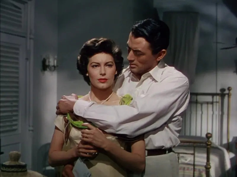 Gregory Peck holds Ava Gardner from behind in a bedroom in The Snows of Kilimanjaro (1952)